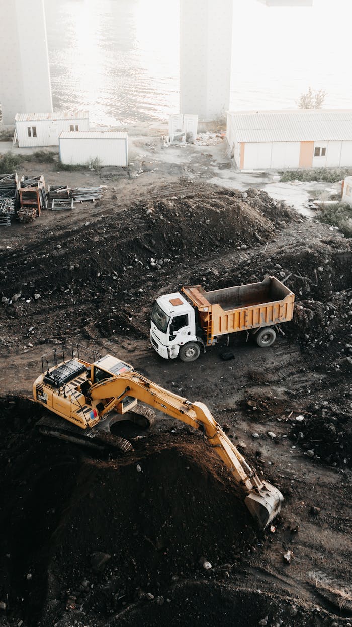Home A high angle view of a construction site in Istanbul featuring an excavator and a truck.
